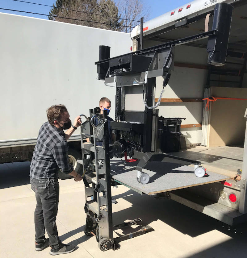 Loading mobile conferencing cart on truck