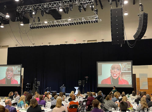 Indoor event with large screens and sound